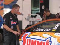 jason line working on his car between nhra pro stock races