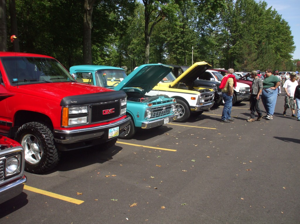row of vintage trucks at a classic car show