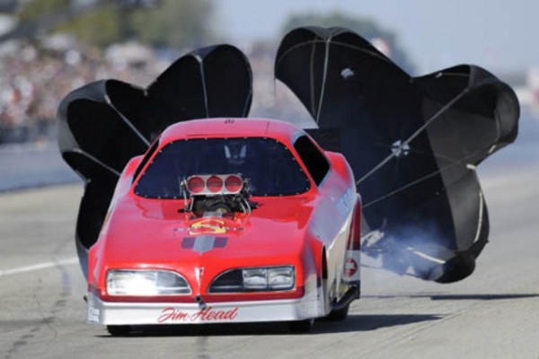 vintage pontiac funny car at end of run with chutes deployed