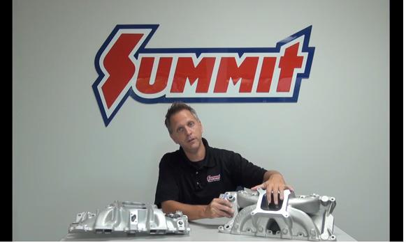 Man holding intake manifolds at a table