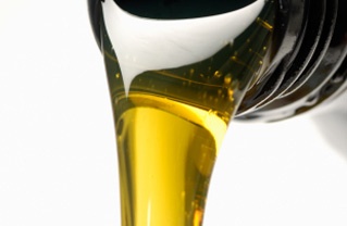close up of motor oil pouring from a bottle