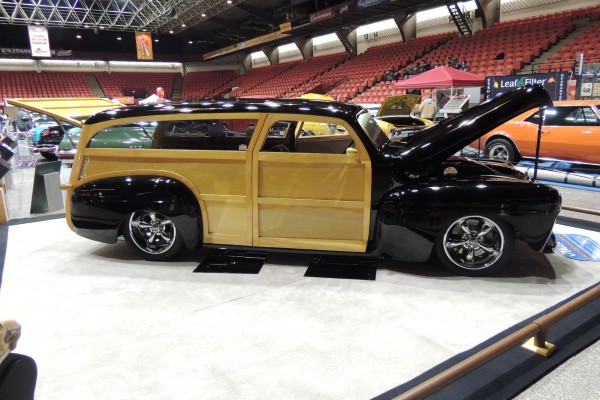 Custom lowered woody wagon displayed at indoor car show