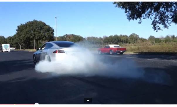 car doing a burnout in a parking lot
