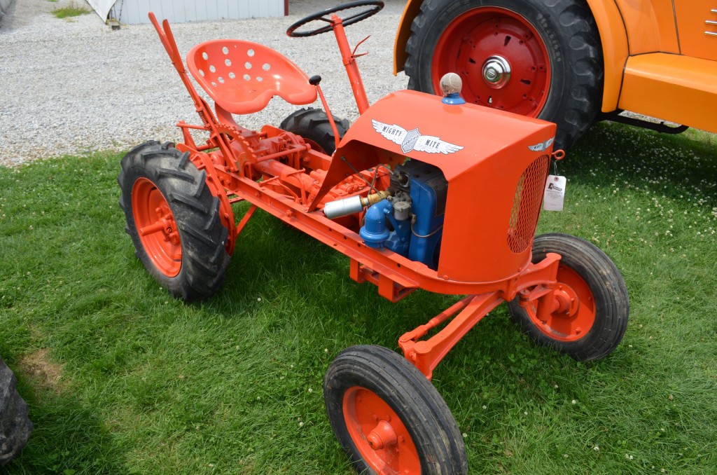 vintage mighty mite lawn tractor at an antique farm equipment show