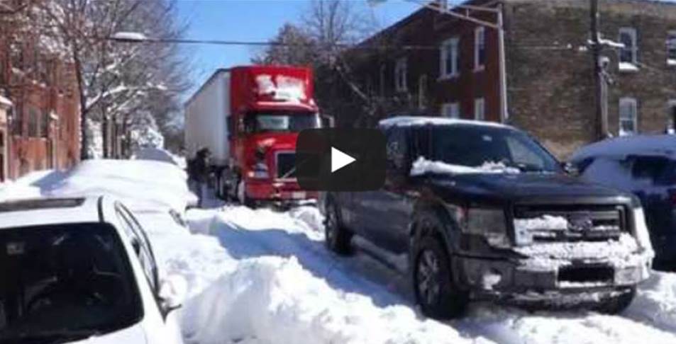 a ford pickup truck pulling a semi trailer through snow