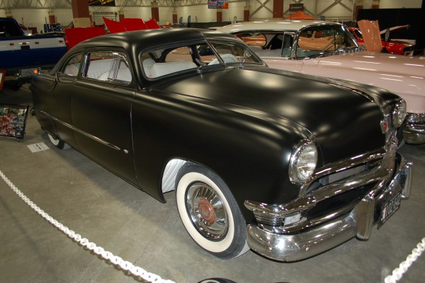 black 1950s ford custom shoebox coupe at vintage car show