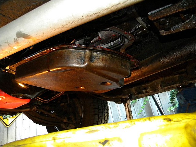 a dirty automatic transmission pan being removed