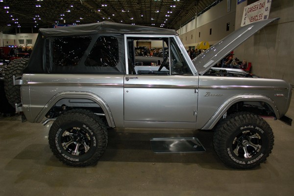 silver first gen ford bronco at indoor car show