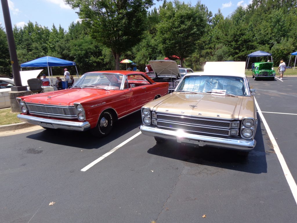 pair of ford galaxie coupes at a car show