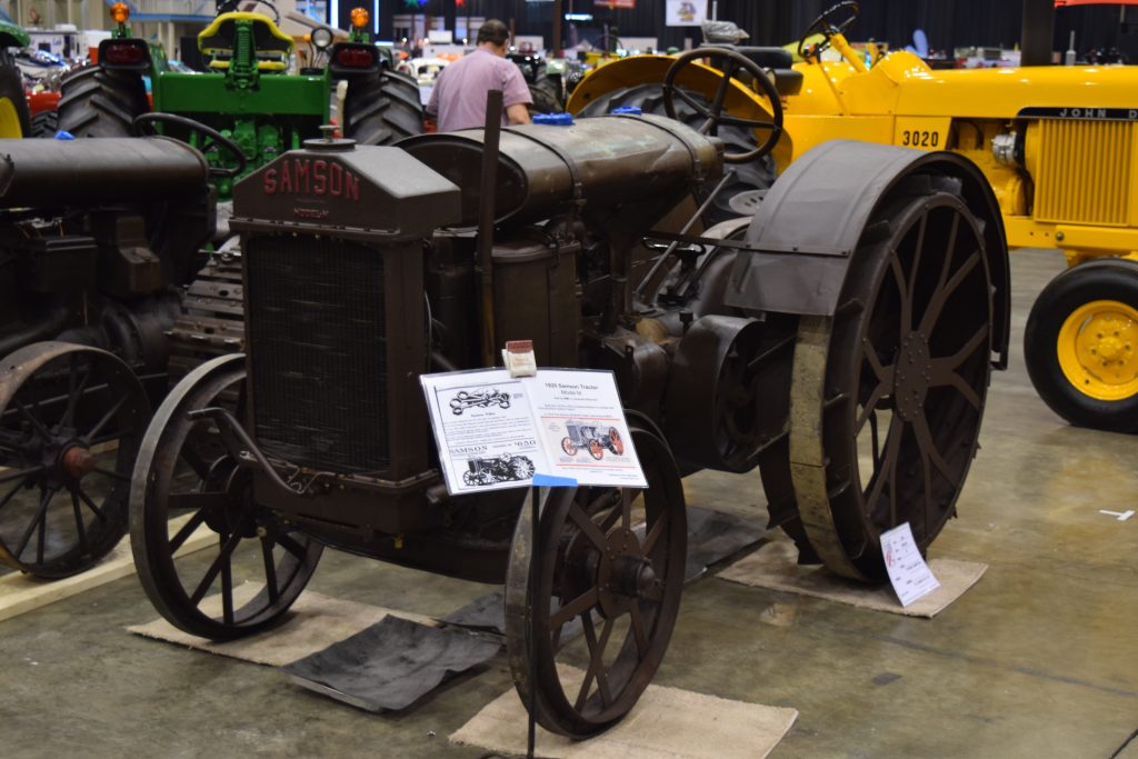 antique samson farm tractor on display at a classic car show