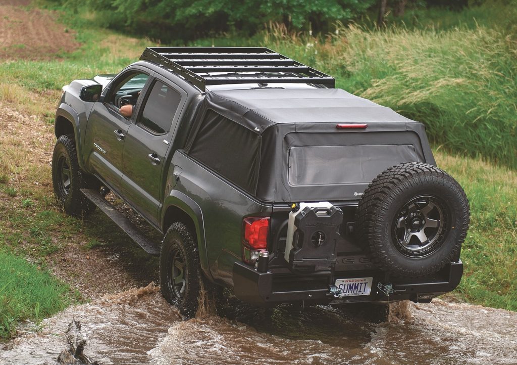 toyota tacoma off roading through a stream