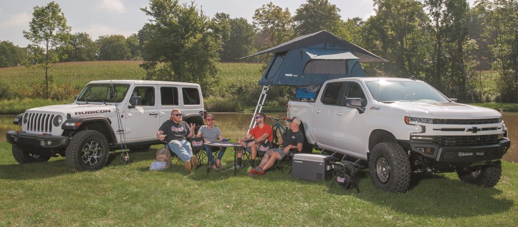 overlanding camp setup with jeep and truck