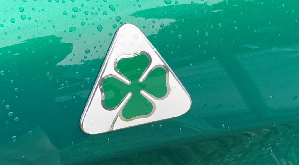 Alfa Romeo Quadrifoglio Verde emblem on a green car