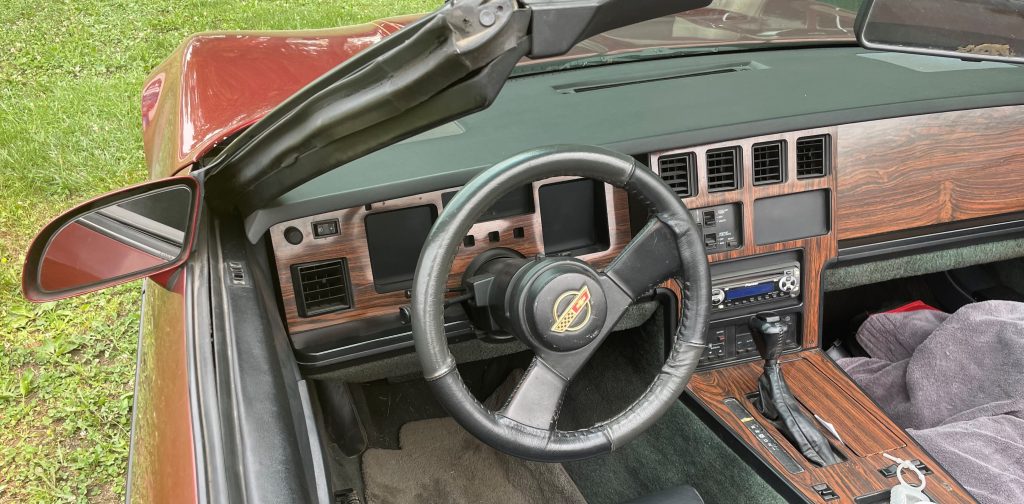 early c4 corvette interior with digital gauges and woodgrain dash