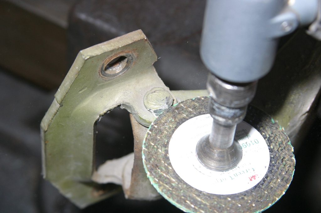 grinding off top or a car door hinge pin