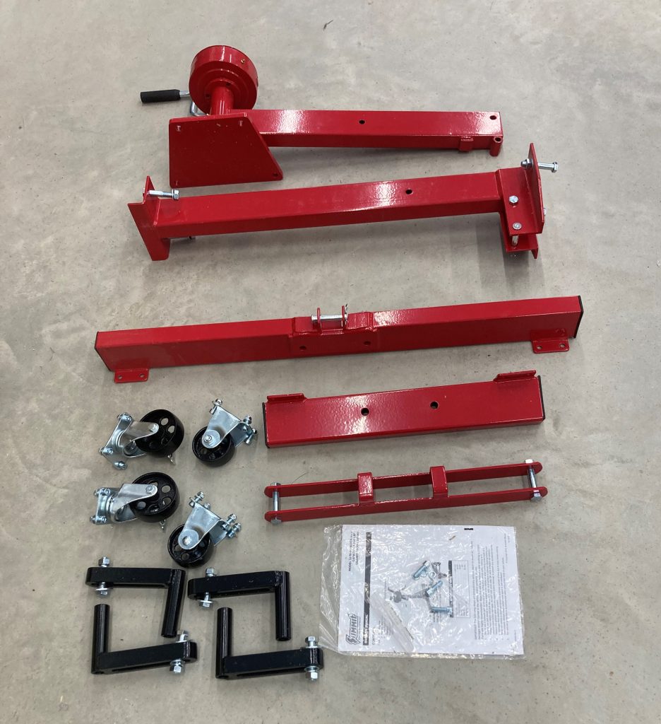disassembled engine stand parts on floor