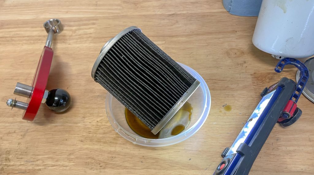 an oil filter that's been cut open on a workbench