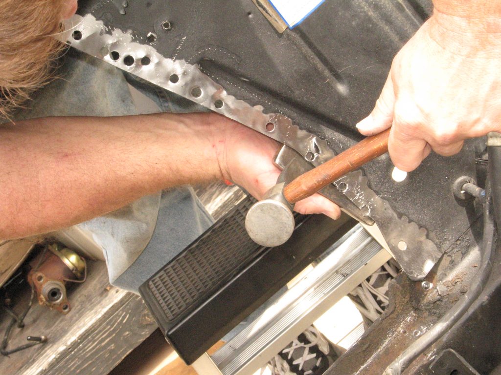 using a hammer to repair bent sheetmetal