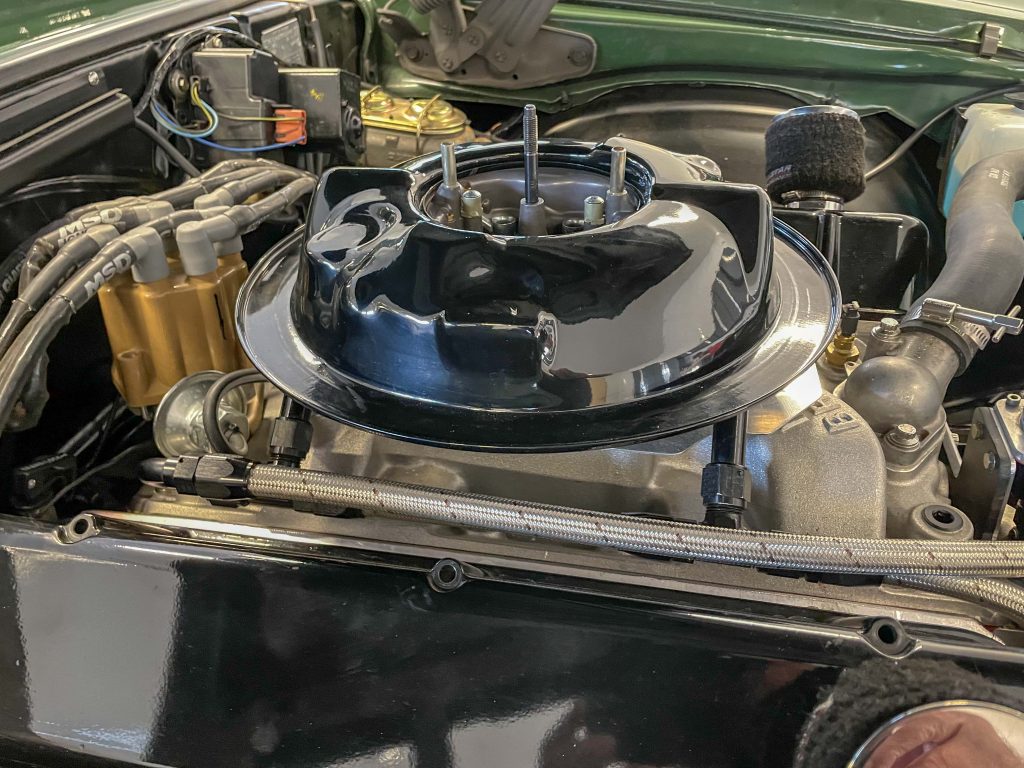 a black air cleaner base installed on a carburetor