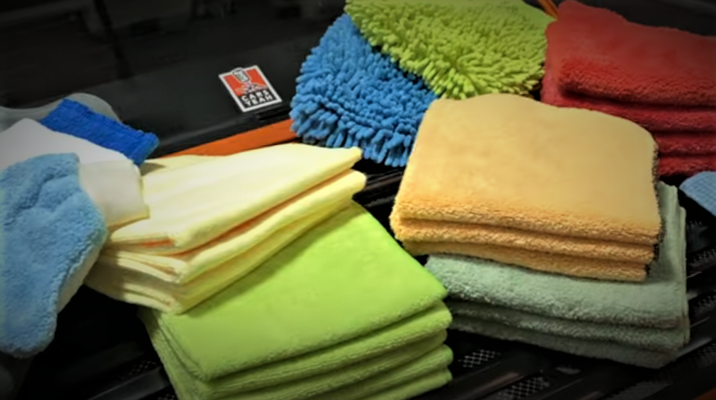 collection of microfiber towels on a porsche spoiler