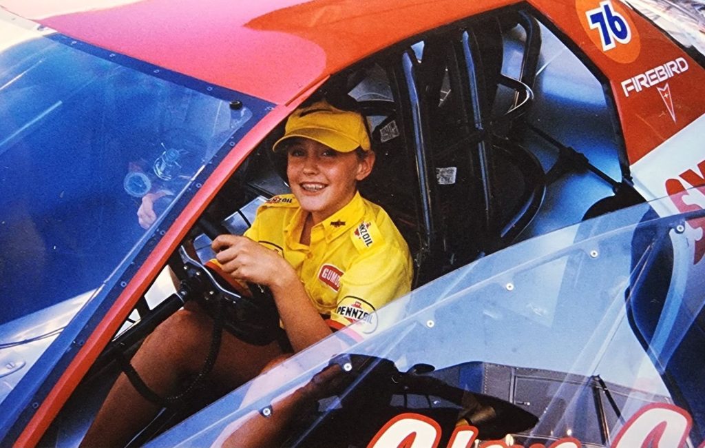 young girl in the cockpit of a drag race car