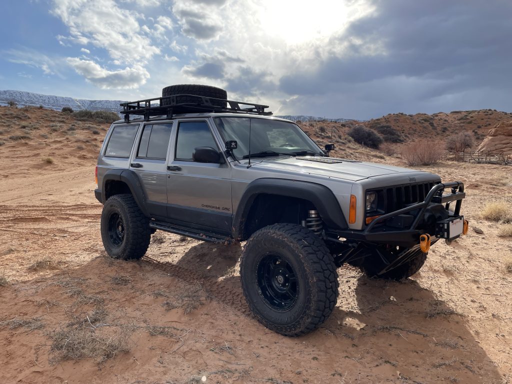 static shot of jeep cherokee XJ on desert trail