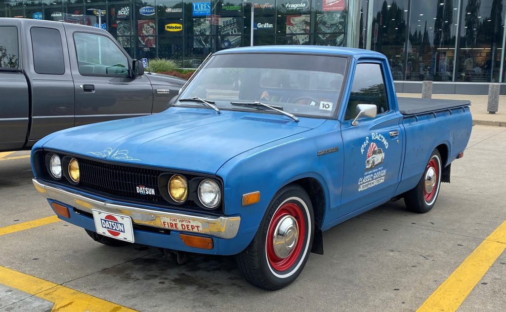 Blue 1976 Datsun Nissan 620 pickup truck, front driver side