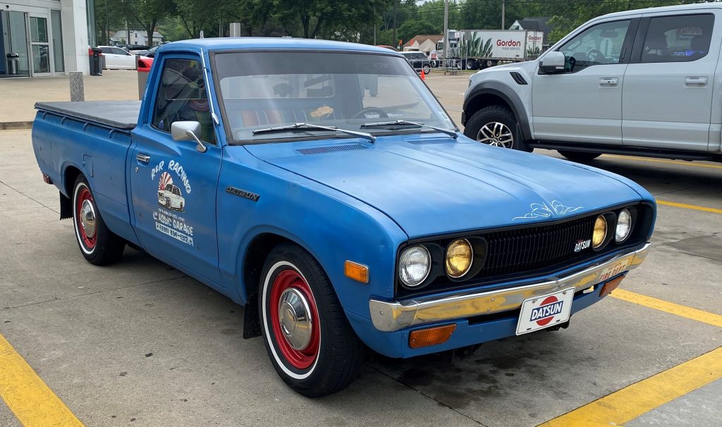 Blue 1976 Datsun Nissan 620 pickup truck, front passenger side