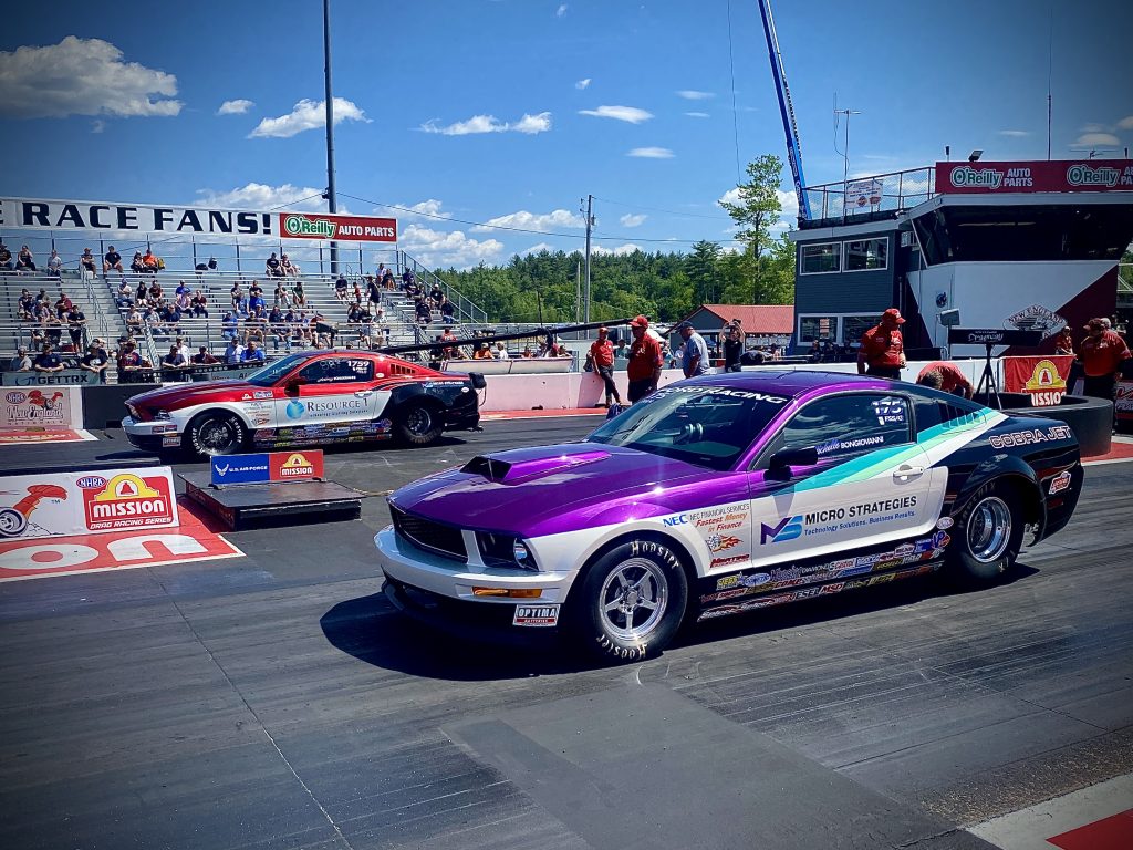 a pair of mustangs staging before a drag race