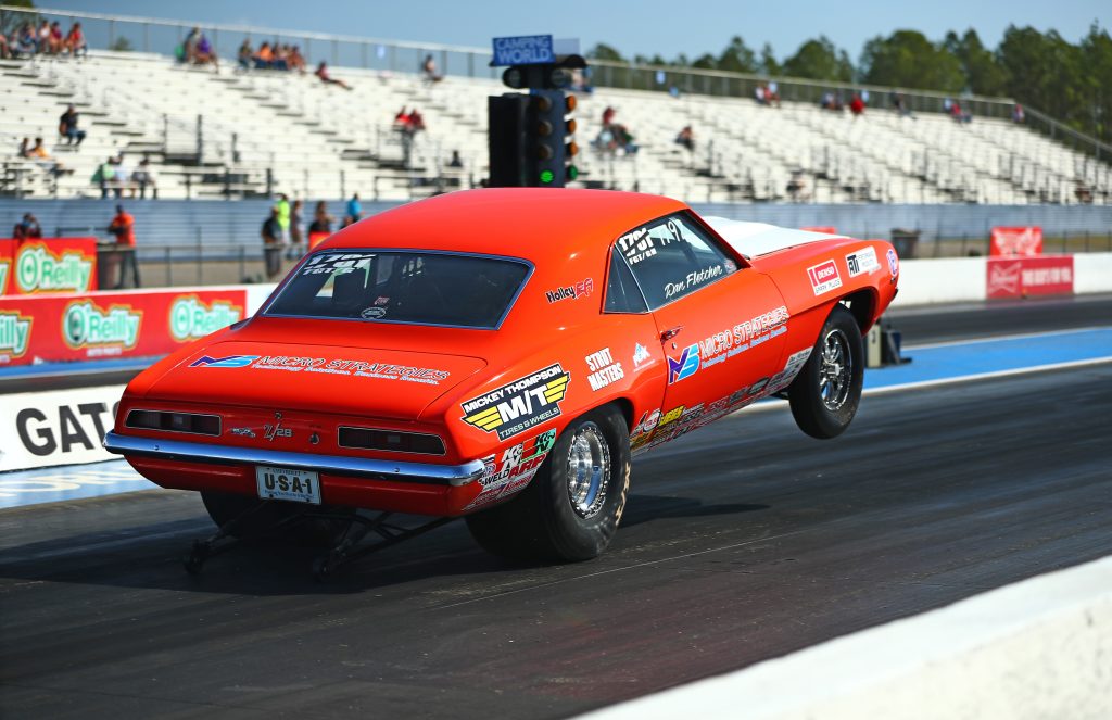 Chevy Camaro Z/28 drag car launching at dragstrip