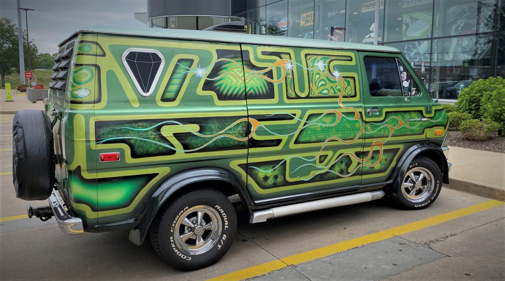 side view of wild paint job on a custom 1974 Ford Econoline van