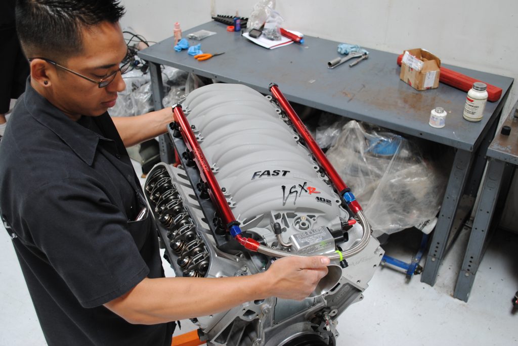 man fitting intake to an ls engine