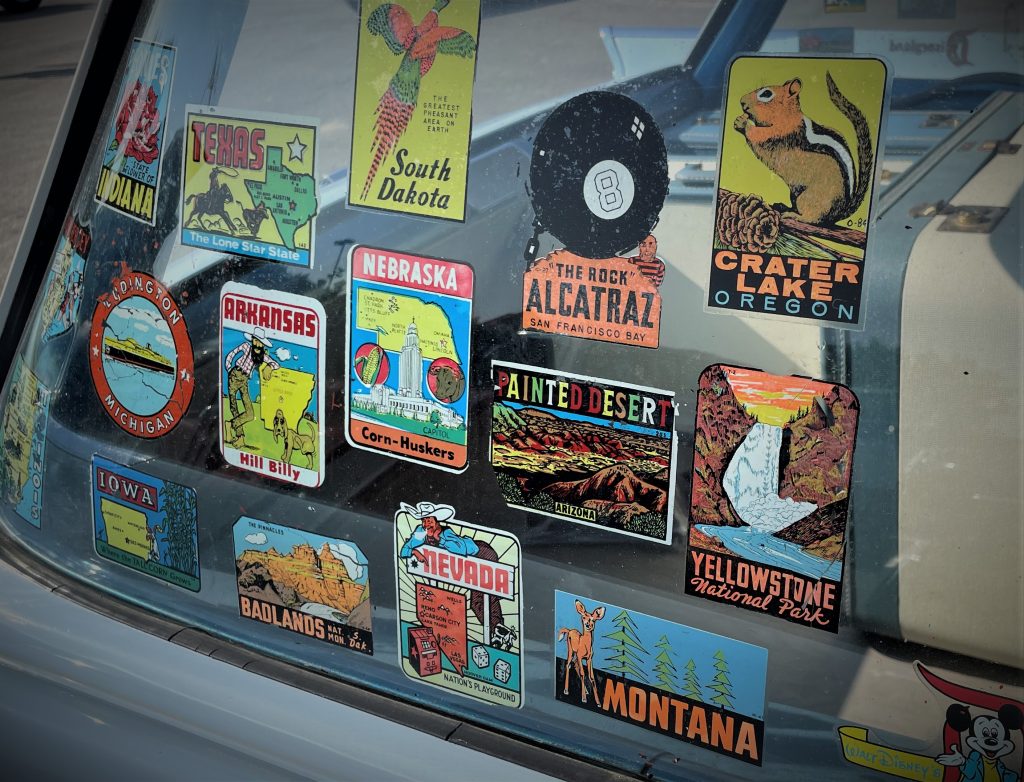 Vintage travel & tourism stickers on a car window