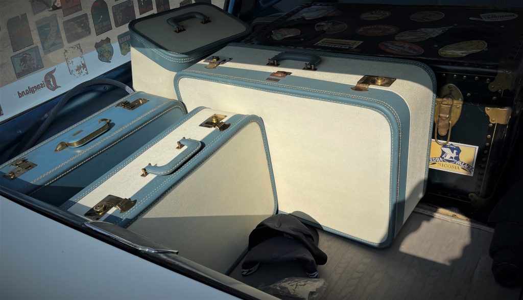 Vintage suitcases in the back of an old station wagon