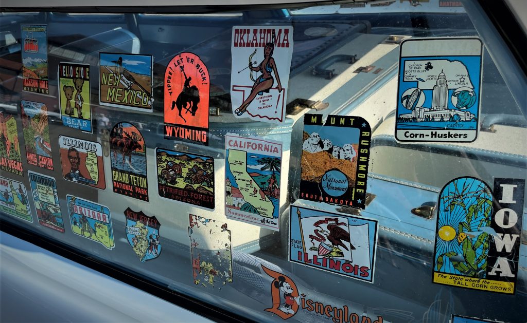 Vintage travel stickers on a old car window