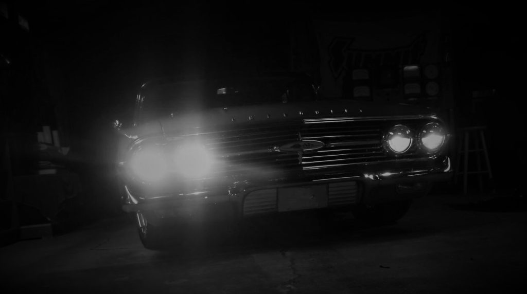 headlight accent on a dark phot of an old car