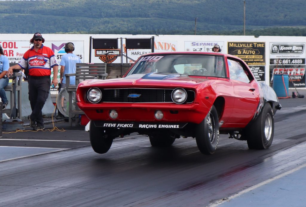 chevy camaro race car launching at dragstrip