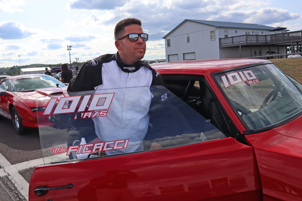 man standing new drag race car door