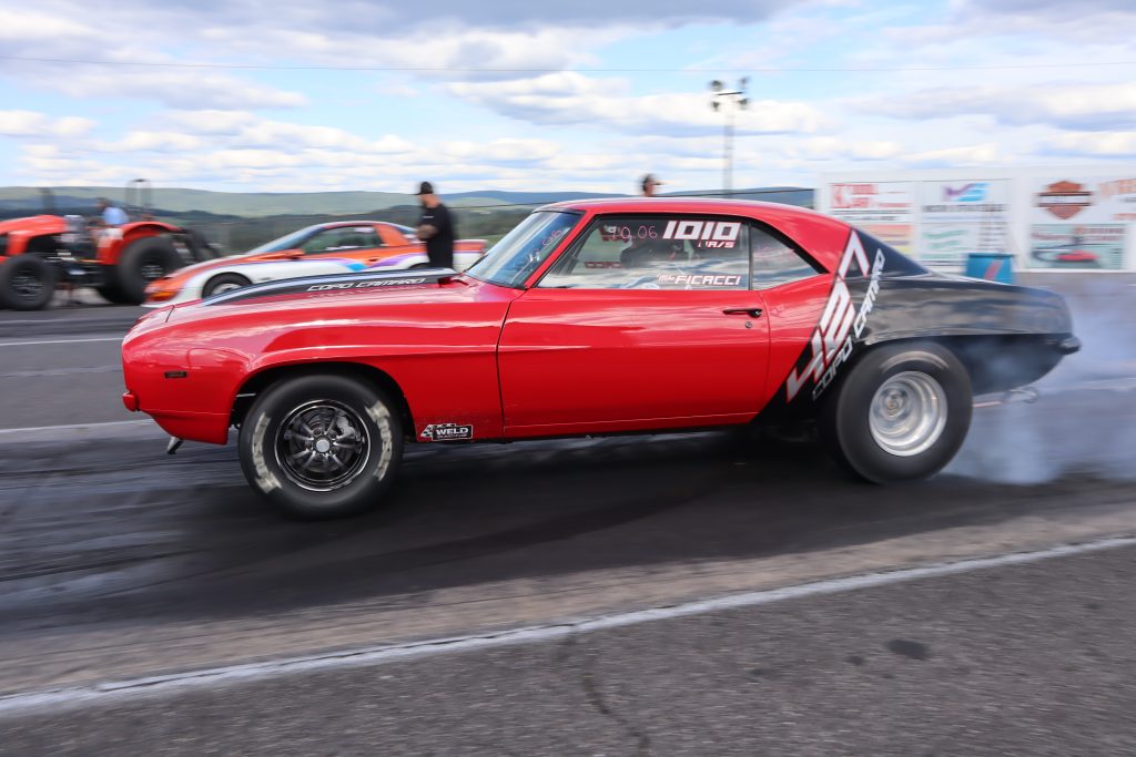 side view of a camaro launching at dragstrip