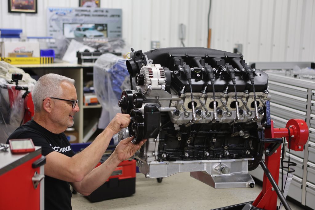 man working on a Ford 7.3L Godzilla engine