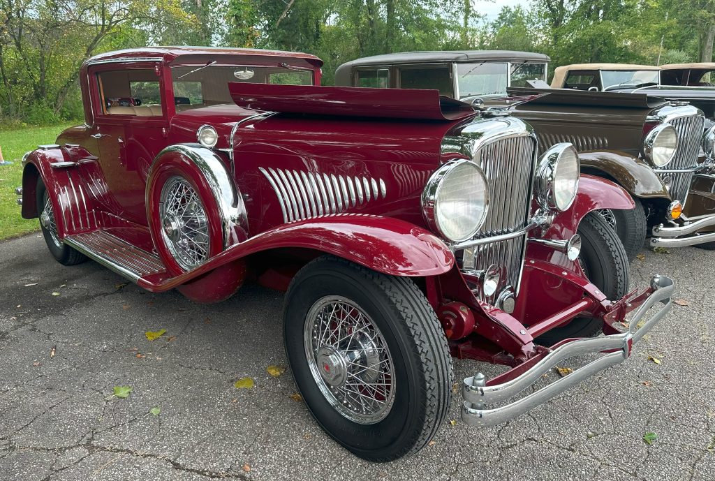 red Duesenberg model J with engine cowl open