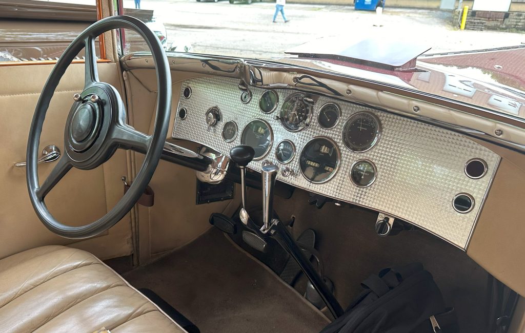 inside a vintage Duesenberg car with engine turned dash