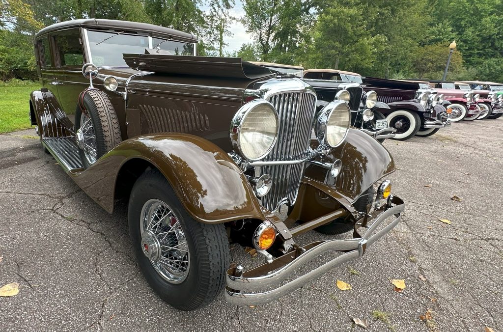 brown Duesenberg coach with engine cowl open