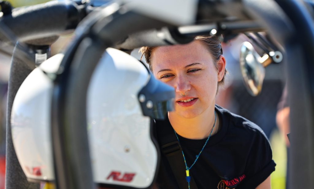 woman talking to man in dragster