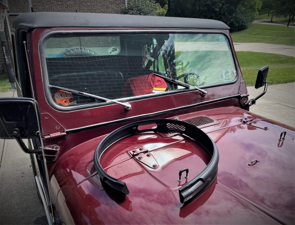 Jeep CJ with a cowl vent seal resting on its hood