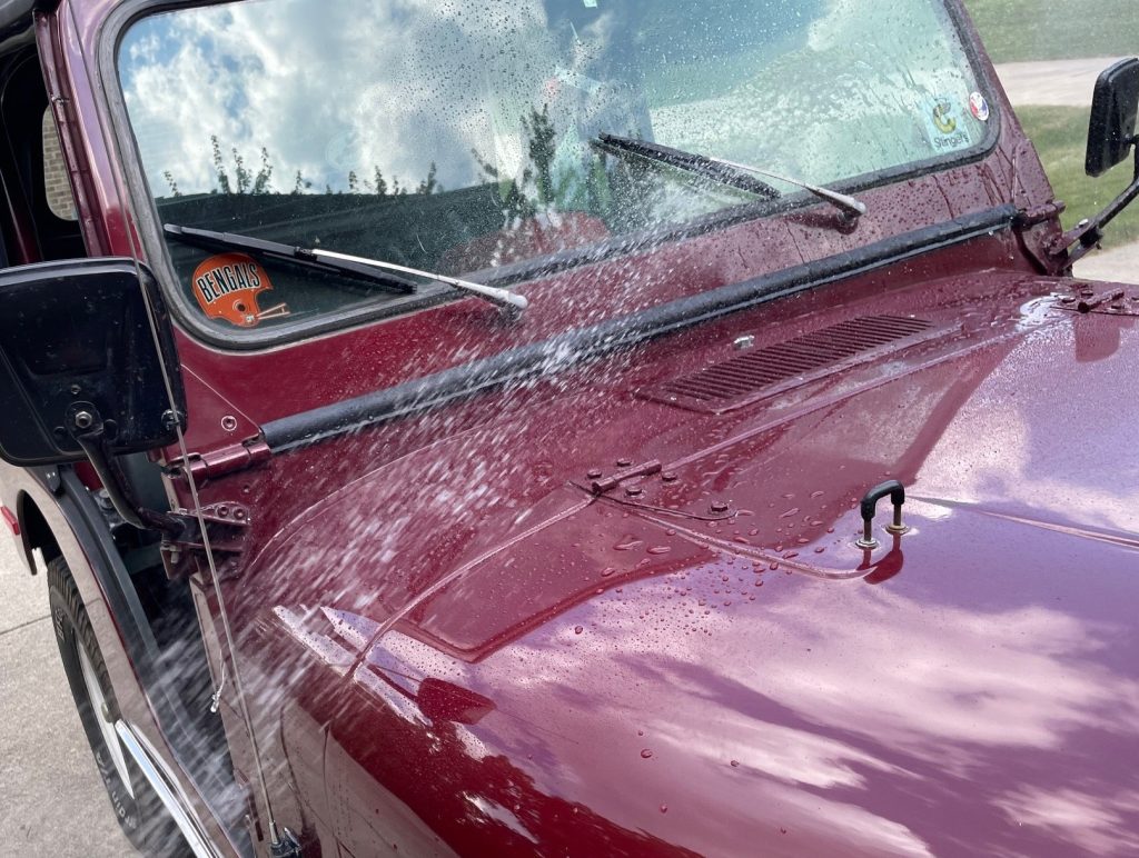 Spraying water onto a jeep windshield 