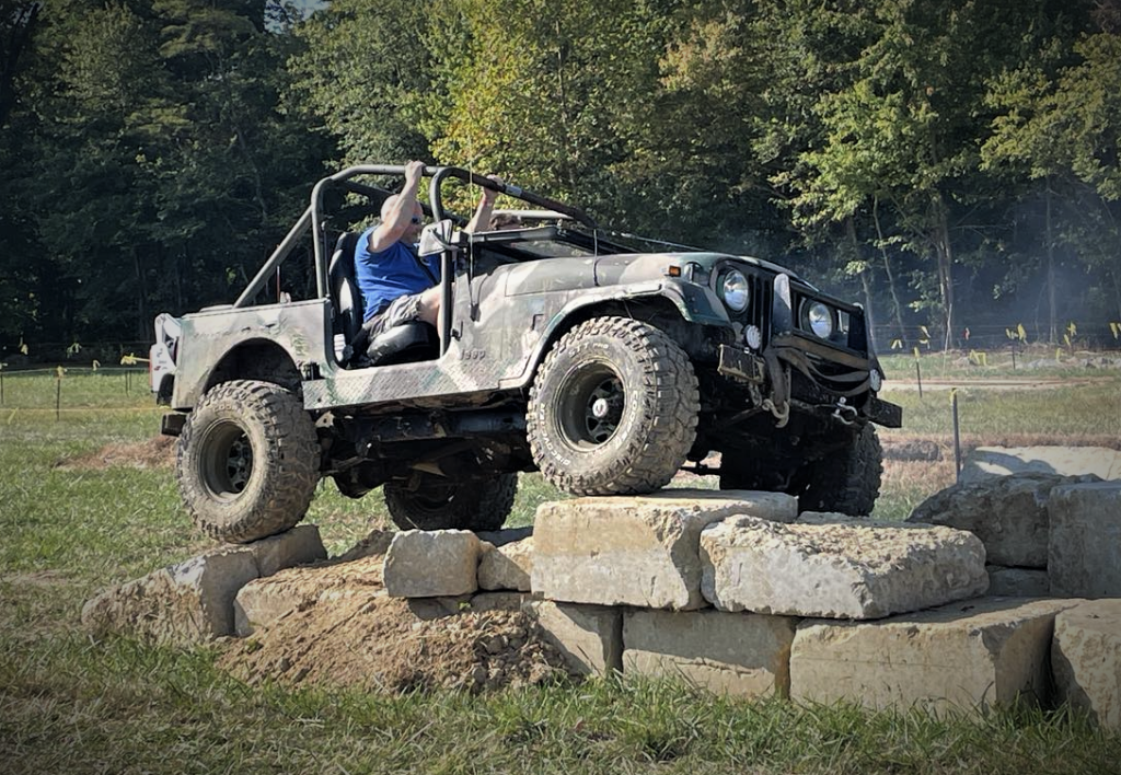 Jeep CJ climbing rocks on an off-road course