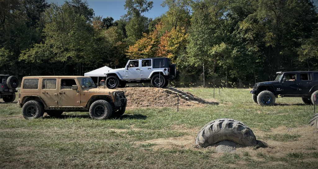 A bunch of wrangler jeeps on an off-road course