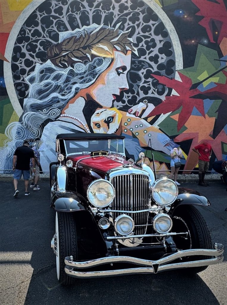 Duesenberg parked near Minerva mural