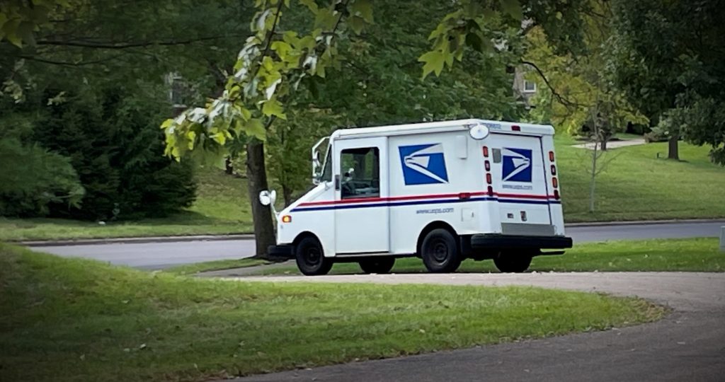 Grumman LLV mail truck in suburban driveway